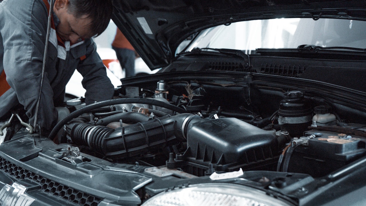 Mechanic working under the bonnet of a car