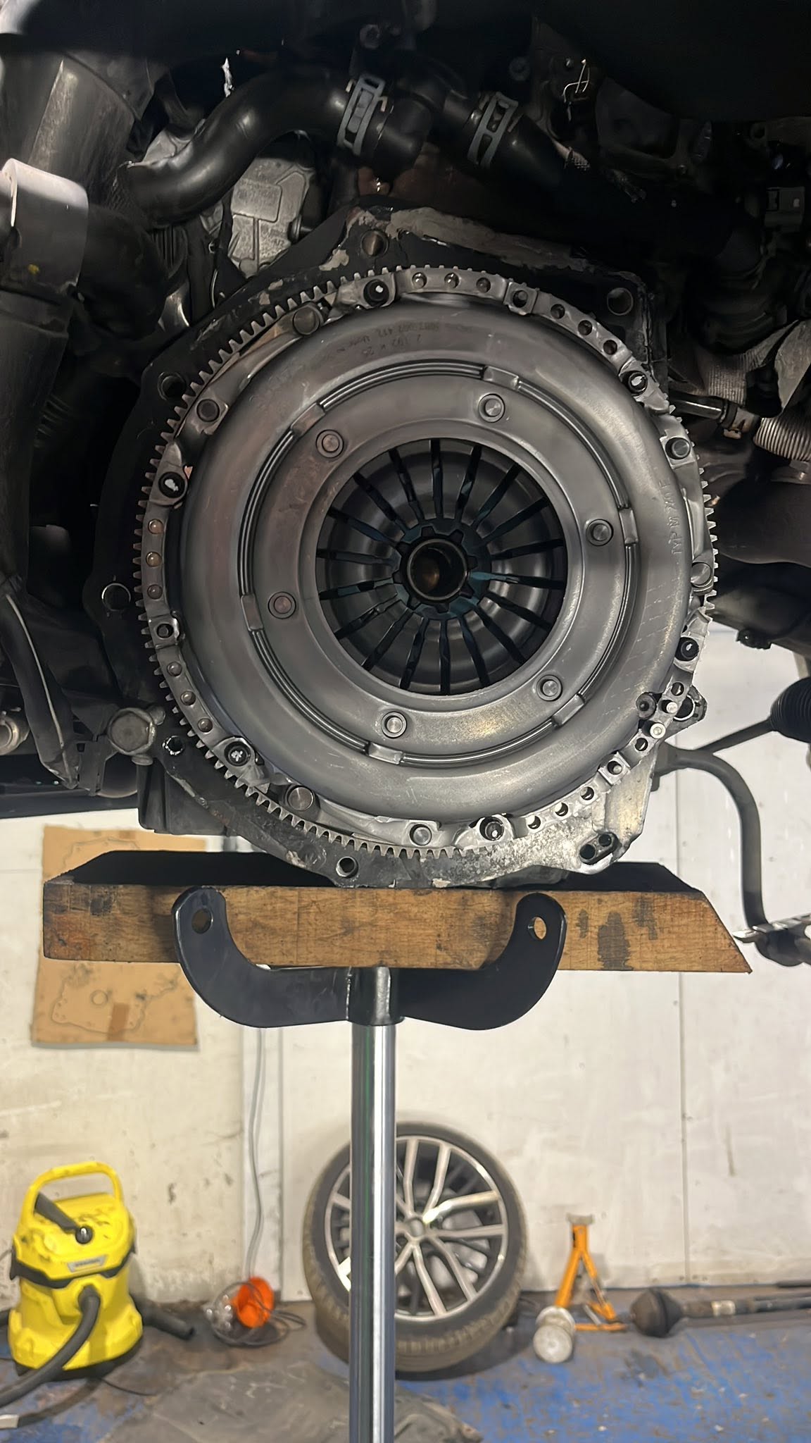 New clutch pressure plate installed on the flywheel with the gearbox removed
