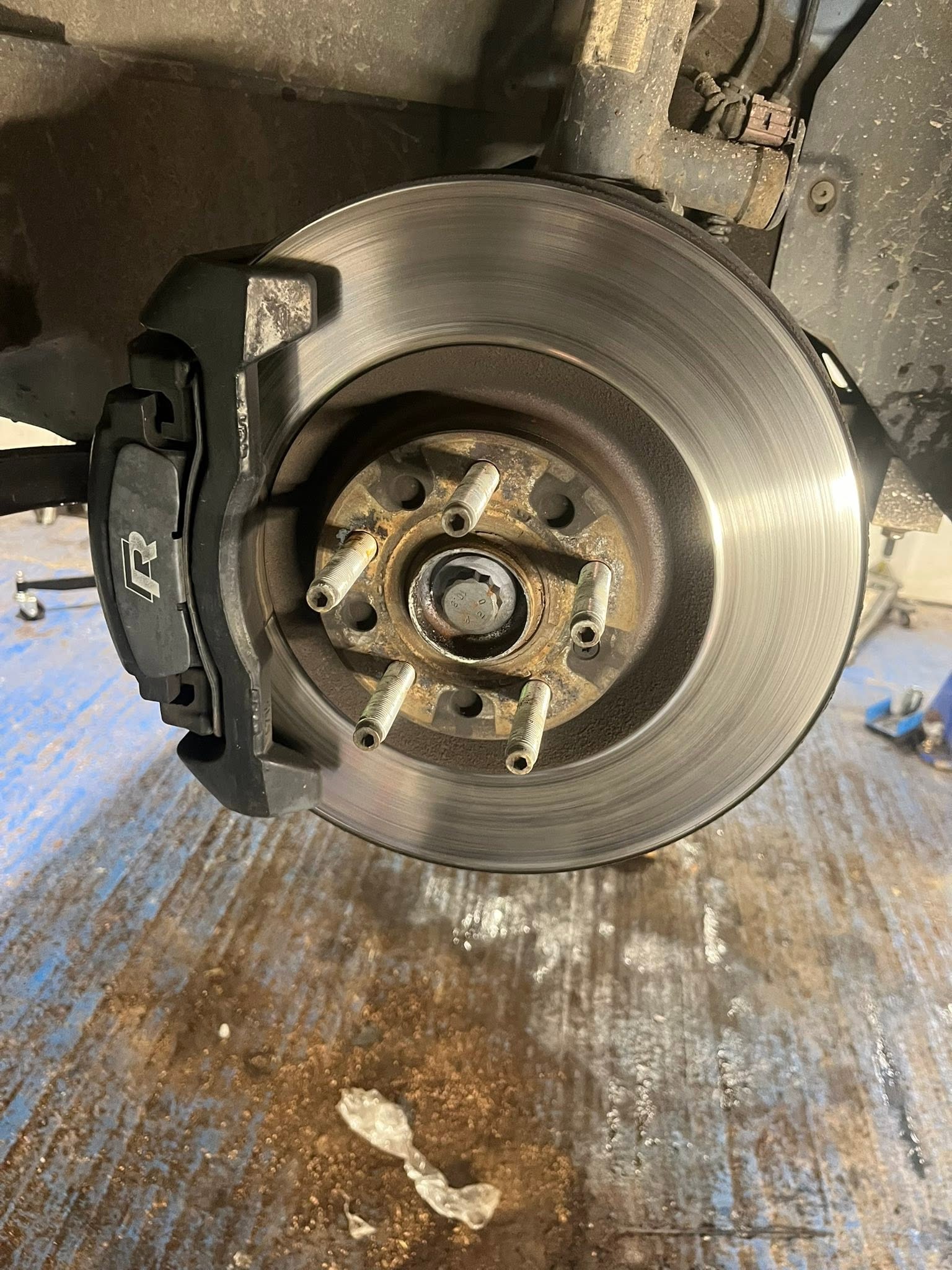 Brake disc and caliper on a car raised on the workshop lift
